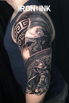 a man with a black and white tattoo on his arm that has an image of a warrior