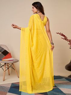 Elevate your wardrobe with our charming yellow sequins georgette haldi wear saree with blouse. This stunning saree is crafted with high-quality georgette material, featuring delicate thread embroidery and sequin work that adds a touch of elegance to the overall look. The vibrant yellow color of the saree is perfect for any festive occasion, especially haldi ceremonies.
The georgette fabric ensures a comfortable and flowy drape, making it easy to move and dance in. The matching art silk blouse co Yellow Chinon Pre-draped Saree, Summer Saree With Mirror Work, Yellow Georgette Pre-draped Saree For Festivals, Yellow Georgette Sharara With Sheer Dupatta, Yellow Semi-stitched Georgette Pre-draped Saree, Yellow Georgette Dupatta For Party, Yellow Lehenga With Chikankari Embroidery In Chinon, Yellow Chinon Lehenga With Chikankari Embroidery, Summer Georgette Pre-draped Saree With Zari Work