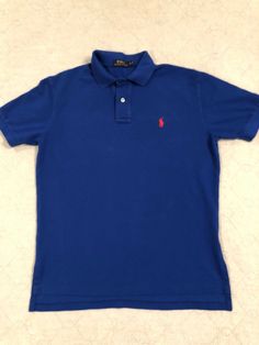 Polo Ralph Lauren short sleeve men’s polo, Excellent, like new condition. Worn and washed twice. No fading. Blue with red pony logo. Size medium. Polo Ralph Lauren Shorts, Blue Polo Shirts, Blue Polo, Men Short Sleeve, Like New, Men's Polo Shirt, Polo Ralph Lauren, Mens Tops, ? Logo