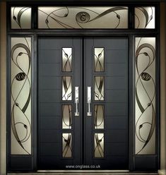 an art deco door with glass panels and decorative designs on the front entrance to a building