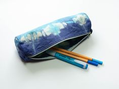 This colorful pencil case with zipper is made of cotton and tie dyed by hand. You can use it as a zipper pouch for pencils or any small things.  It can be washed by hand. Dimensions:  Length 21 cm, diameter 6 cm on the sides. No lining. Every pouch is special and unique. The colours can slightly differ from the picture. Cotton Pencil Case With Pen Holders For Personal Use, Cotton Pencil Case With Zipper, Cotton Pencil Case With Zipper Pouch, Colored Pencil Case, Beautiful Tshirts, Color Crafts, Zippered Pouch, Cute Stationery, Pencil Pouch