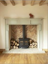 a fireplace with logs stacked on top of it