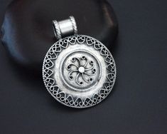 "A round and medium sized Indian sterling silver amulet. All the silver ornamentations are fully intact and it looks really pretty. The back is stamped 925 and the long bale is large enough for a thicker chain or cord. Measurements are: Diameter Amulet 3.5cm (1.4\") Weight: 11gr. This pendant ships registered priority and with tracking ❀ Please read my shop and return policies before purchasing ❀ https://www.etsy.com/shop/CosmicNorbu/policy?ref=shopinfo_policies_leftnav" Traditional Round Disc Jewelry As Gift, Traditional Nickel-free Round Pendant Jewelry, Indian Pendant, Nepali Jewelry, Lapis Pendant, Tibetan Jewelry, Hand Of Fatima, Coral Turquoise, Ethnic Jewelry