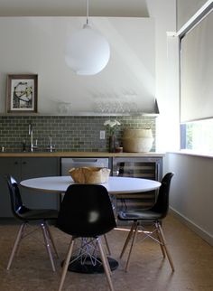 a kitchen table with four chairs around it