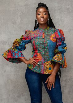 Our Amari long sleeve mandarin collar shirt in New Harvest Multipattern print is perfect for a refined aesthetic. The shirt's puff sleeves elevate the style with a feminine touch. The top may be dressed up with slacks and heels for the office, or down with a pair of black jeans and flats for a more laid-back vibe. Ankara Top Styles, African Print Top, Modern African Clothing, African Blouses, Ankara Tops, African Tops, African Print Tops, Mandarin Collar Shirt, African Print Clothing