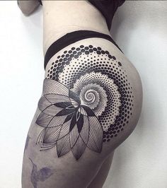 a woman's thigh with an abstract flower tattoo on her left leg and black dots around the thighs