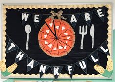 a black and orange banner with words that say we are grateful on it, surrounded by utensils