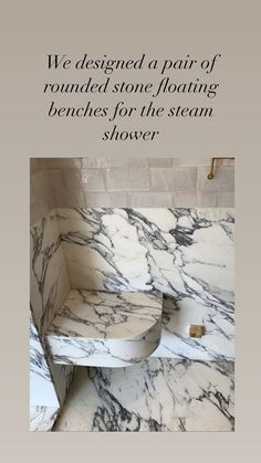 a white and black marble shower with the words, we designed a pair of rounded stone floating benches for the steam shower