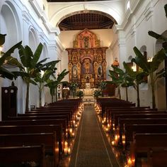 the interior of a church with candles lit