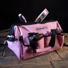 a pink tool bag with tools in it