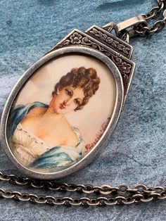 This antique miniature painting is just amazing with beautiful details  ( a beautiful woman with lace dress) on ornate sterling silver medal ,  the painting singed :  F. CORELLI , it's  in excellent antique condition without any hurt , the heavy ornate frame is just outstanding   ,  with eagle head stamp , it will be send with her original chain of 50cm . Quautity :  One Dimensions :  28mm  x  50mm`( height with bale ) Necklace : 20 inches  Weight : 16.5 grams  Material of item : sterling silver Antique Silver Victorian Necklace, Necklace Woman, Saints Medals, Eagle Head, Ornate Frame, French Antique, Miniature Painting, Just Amazing, Beautiful Woman