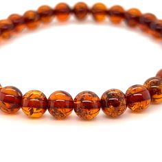 Boho-Chic Amber Bead Bracelet from Super Silver, perfect for adding a touch of elegance to any outfit. Handcrafted with genuine Baltic amber beads, this bracelet is not only stylish but also believed to possess healing properties. Amber Beaded Bracelets For Meditation, Hand-strung Amber Beaded Bracelets For Meditation, Amber Beaded Bracelets With Natural Stones, Hand-strung Round Amber Bead Jewelry, Hand-strung Amber Jewelry With Round Beads, Spiritual Amber Bracelets With Polished Beads, Orange Hand-strung Spiritual Bracelets, Hand-strung Orange Spiritual Bracelets, Orange Hand-strung Healing Bracelets