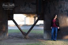 a woman standing in front of a metal structure