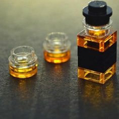 two small glass containers sitting on top of a table