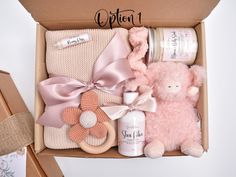 a pink teddy bear and other items in a box