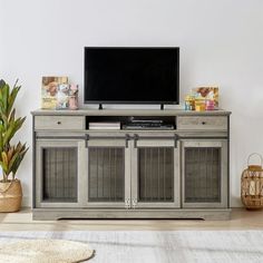 a flat screen tv sitting on top of a wooden cabinet