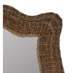 a mirror made out of wicker sitting on top of a table