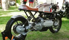 a motorcycle parked on top of a lush green field