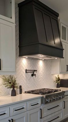 a stove top oven sitting inside of a kitchen next to white cabinets and counter tops