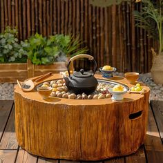 a tea kettle sitting on top of a wooden table