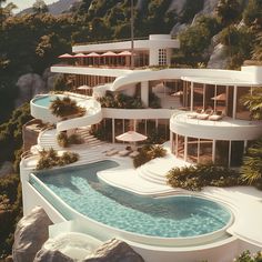 an aerial view of a house with a pool in the foreground and mountains in the background