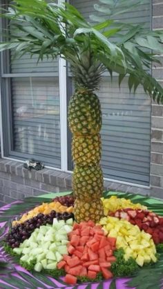 a pineapple tree surrounded by fruit and vegetables