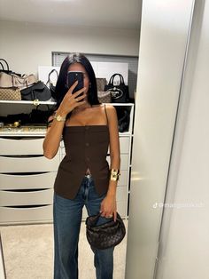 a woman is taking a selfie in the mirror with her cell phone and purse