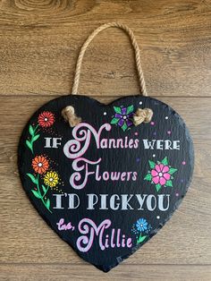 a wooden heart hanging on a wall with the words if nannies were flowers, i'd pick you in millie