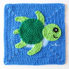 a crocheted square with a green turtle on it