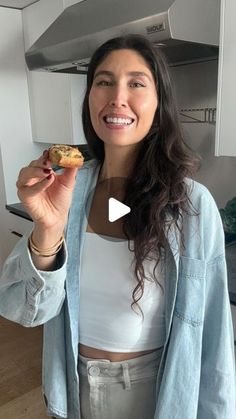 a woman holding a cookie in her right hand