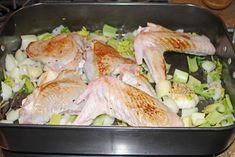 chicken and vegetables cooking in a pan on the stove top, ready to be cooked