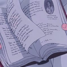 someone holding an open book with writing on it