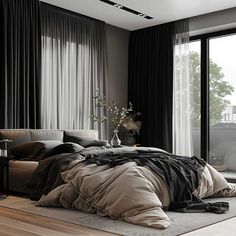 a large bed sitting next to a window in a room with black drapes on the windowsill