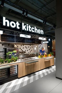 the interior of a hot kitchen with lots of counter space and signs on the wall