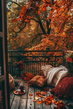 an autumn scene with leaves on the ground and a coffee cup in front of it