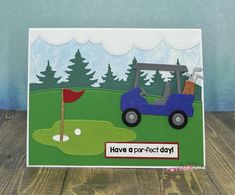 a handmade card with a golf cart on the green and trees in the background