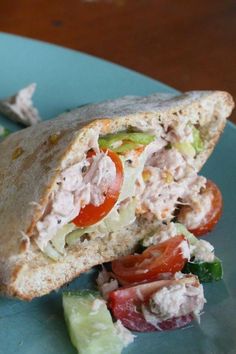 a sandwich cut in half sitting on top of a blue plate