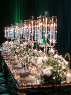 a long table is set with candles and flowers for a formal dinner or banquet event