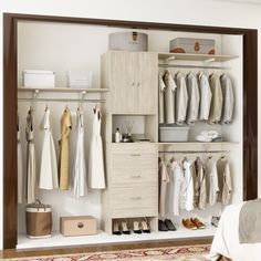 a closet with clothes and shoes hanging on the wall next to a bed in a room