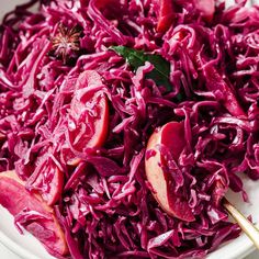 red cabbage and apples in a white bowl with chopsticks on the side, ready to be eaten