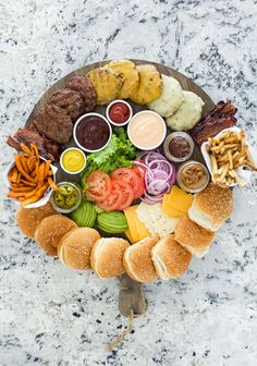 a platter filled with different types of food on top of a marble countertop