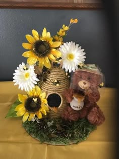 a teddy bear and sunflowers in a birdhouse