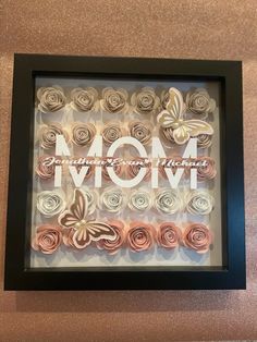 a mom's day shadow box frame with rolled flowers in the shape of roses