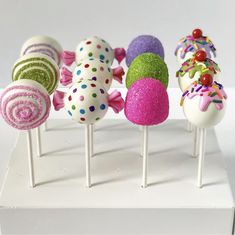 there are many different types of cake pops on the stick in front of each other