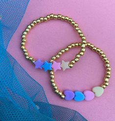 These fun bracelets are stylish and chic for young girls. Perfect for stocking stuffers, birthday gifts, friendship bracelets, the list can go on. Bracelet listing includes one bracelet of your choice. If you would like different colored beads than the gold please send me a message Pair with our other stacking bracelets to make a cute custom stack! PRODUCT DETAILS: - Bracelets are made with stretchy quality jewelry elastic - All orders are FINAL SALE as they are custom orders. Please double chec Cute Handmade Gold Beaded Bracelets, Cute Gold Stretch Bracelet With Letter Beads, Gold Heart-shaped Beaded Bracelet For Birthday, Playful Personalized Gold Beaded Bracelets, Playful Round Beads Jewelry For Valentine's Day, Trendy Gold Bracelets With Heart Beads, Playful Gold Jewelry With Letter Beads, Playful Valentine's Day Jewelry With Round Beads, Trendy Heart Beads Jewelry For Birthday