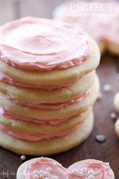 a stack of cookies with pink frosting on top