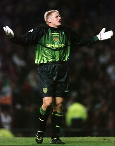 a soccer player with his arms outstretched on the field