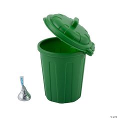 a green plastic trash can next to a silver cone