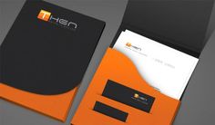 an orange and black business card holder with two envelopes on the front, and one in