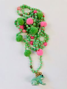 "long fantasy necklace. Nice happy colors light green and pink at the end there is a ceramic frog with crown that will be your prince when you kiss it !! funny ideal for this summer  between the 4\" czech beads there are some small pompom" Fantasy Necklace, Ceramic Frogs, It Funny, Long Beaded Necklace, Green And Pink, Czech Beads, Happy Colors, Pom Poms, The 4